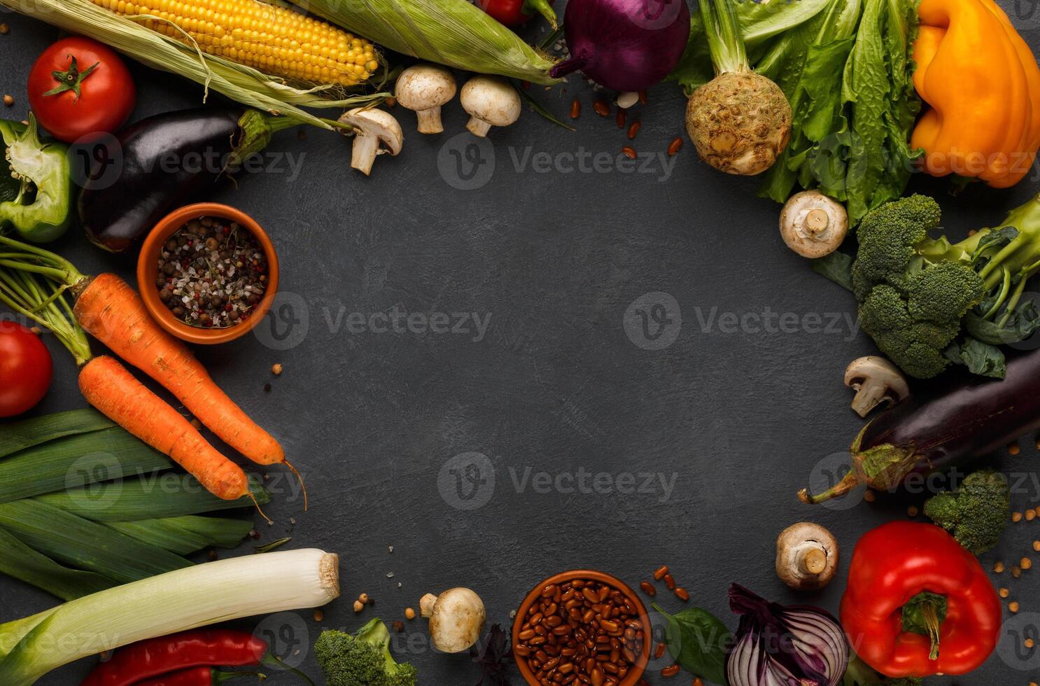 Frame of fresh organic vegetables on wood background. Healthy natural food on rustic wooden table with copy space. Beans and sea satl, carrot, pepper, broccoli and other cooking ingredients top view photo
