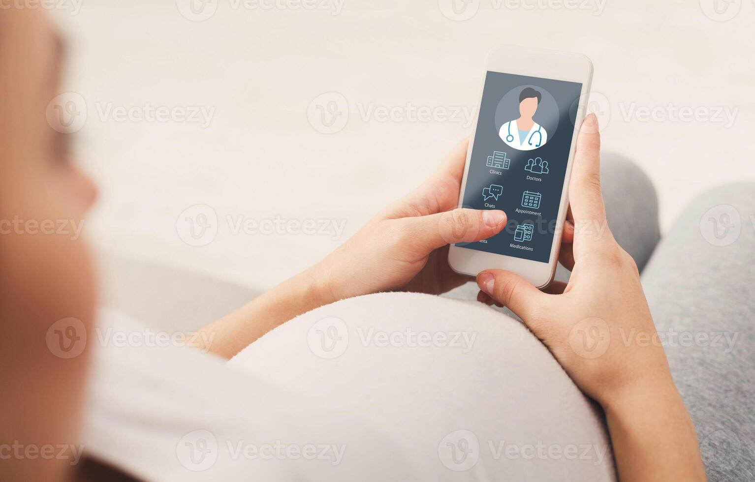 Pregnant lady using online medical service on mobile phone while staying home, calling or chatting with her doctor, register appointment on Internet, over shoulder shot, copy space, collage photo