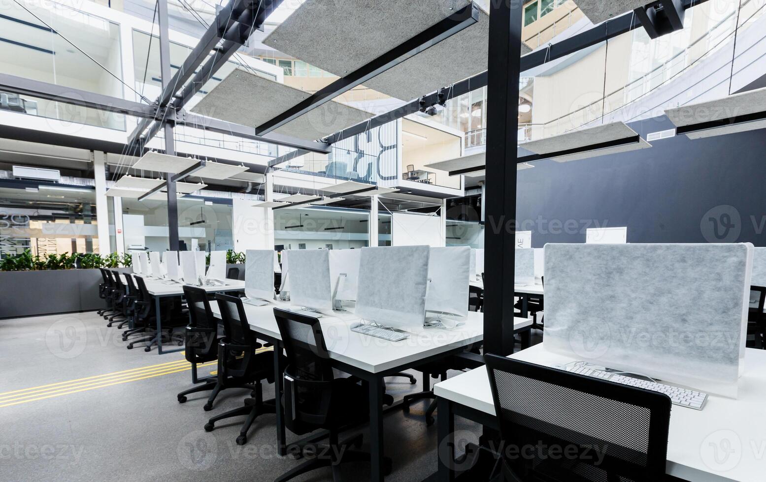 World pandemic, remote work. Light modern open space office with computers, no people photo