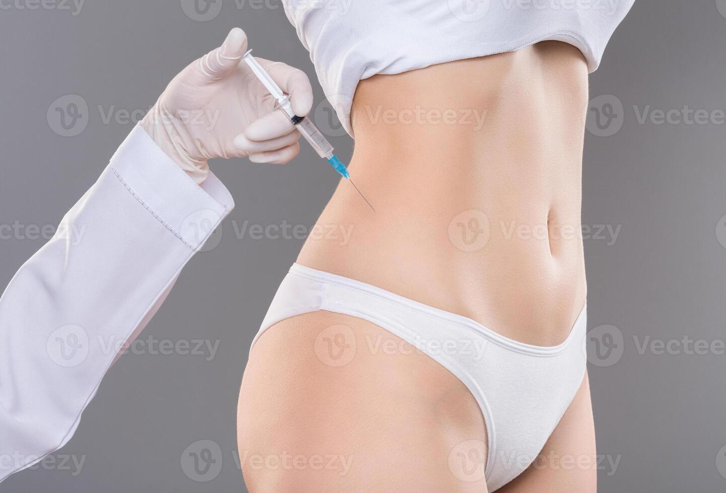 Beauty injection for slimming. Young woman getting lipolysis treatment at plastic surgery clinic, closeup photo