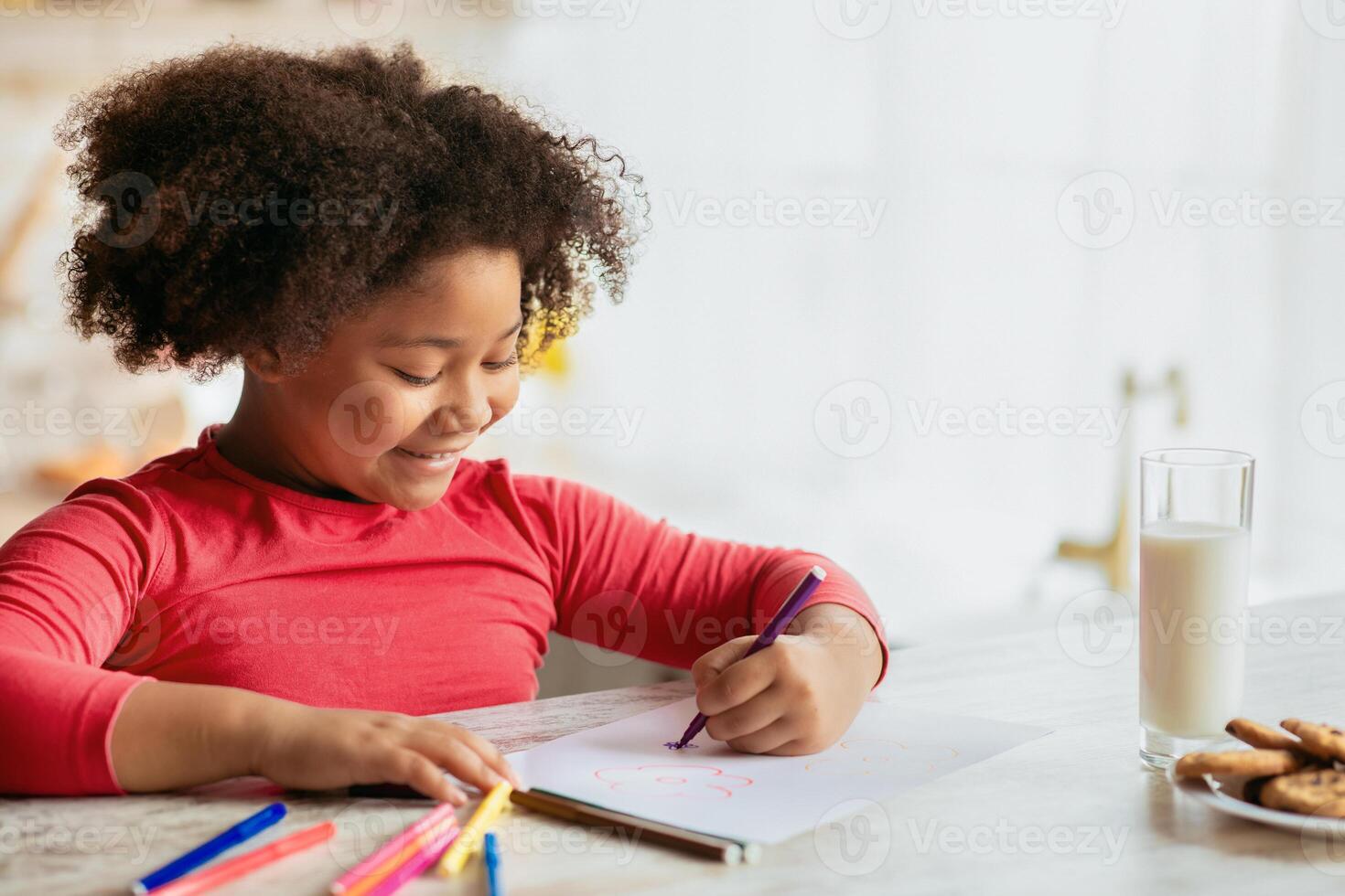 Preschool Activities. Adorable Little Black Girl Drawing With Colorful Pencils In Kitchen, Cute African American Female Kid Sitting At Table With Cookies And Milk, Enjoying Spending Time At Home photo
