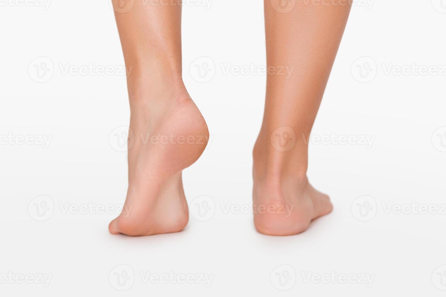 Footcare. Close up of female legs with smooth sole, white studio background photo