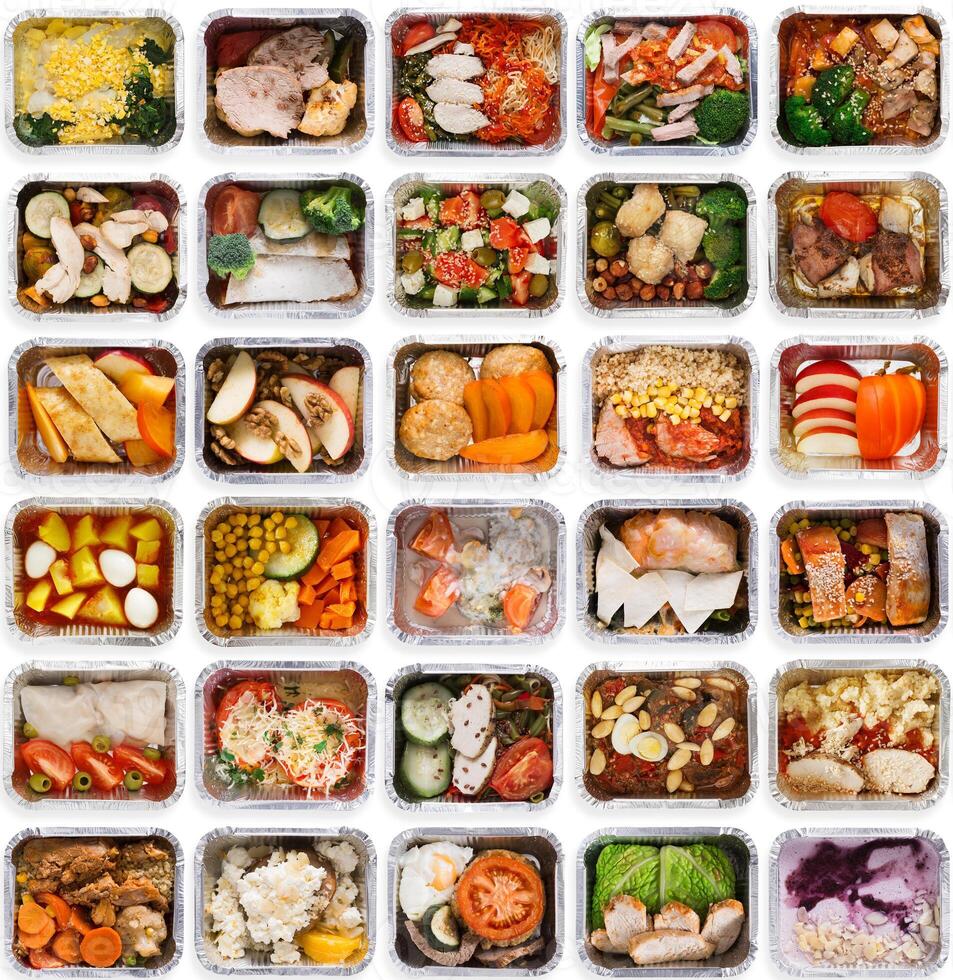 Collection of take away foil boxes with healthy food. Set of containers with everyday meals - meat, vegetables and law fat snacks on white background, top view photo