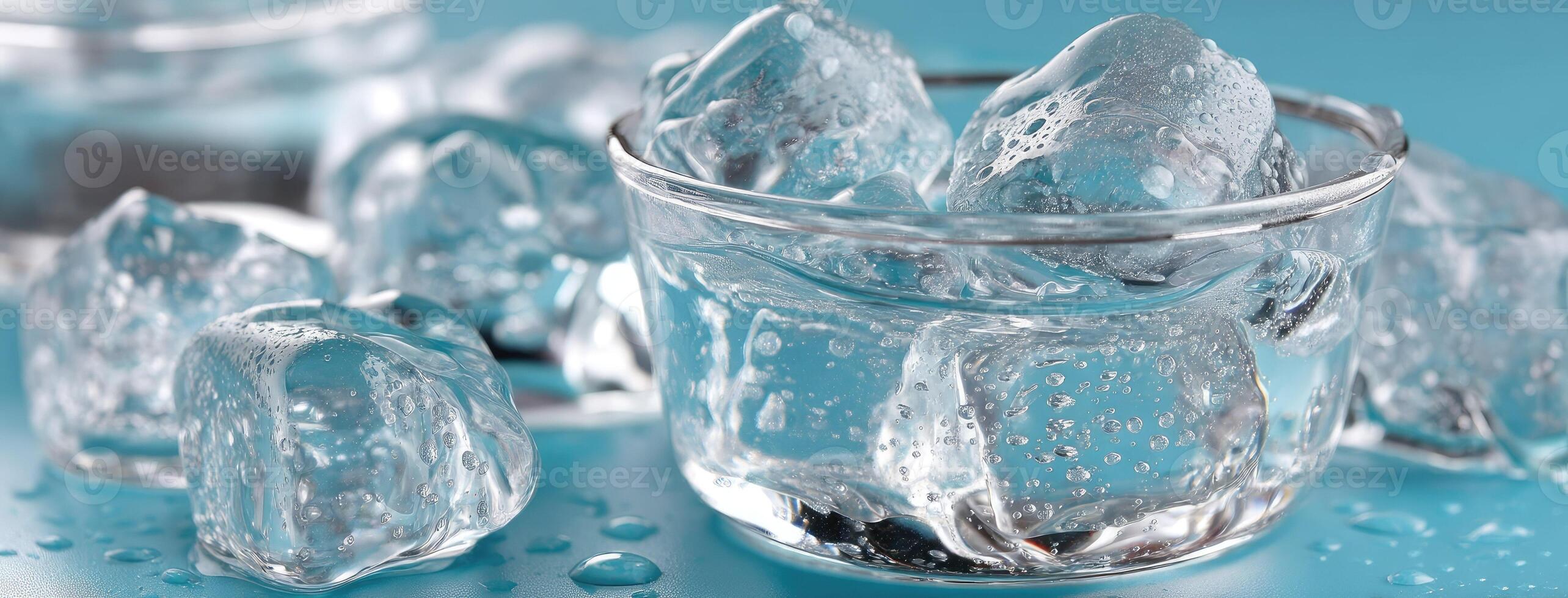 Ice cubes in a glass with water on a blue background photo