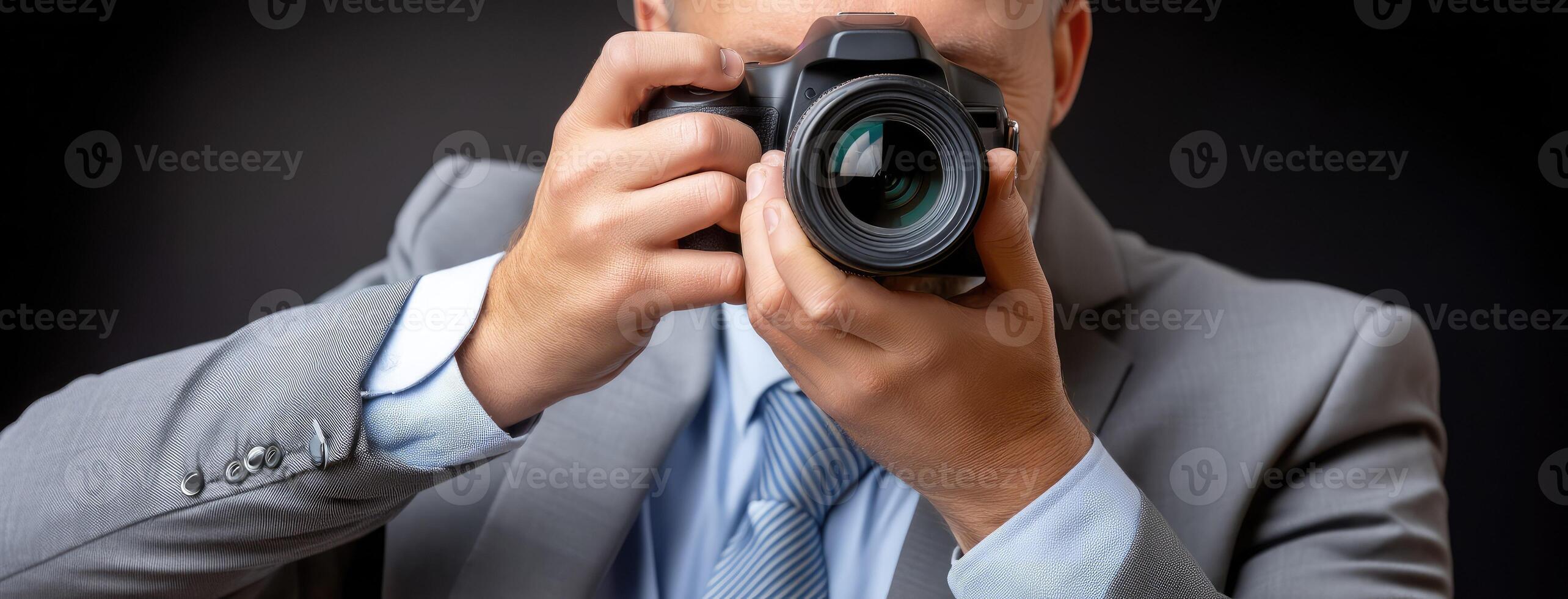 A man in a suit is taking a picture with his camera photo