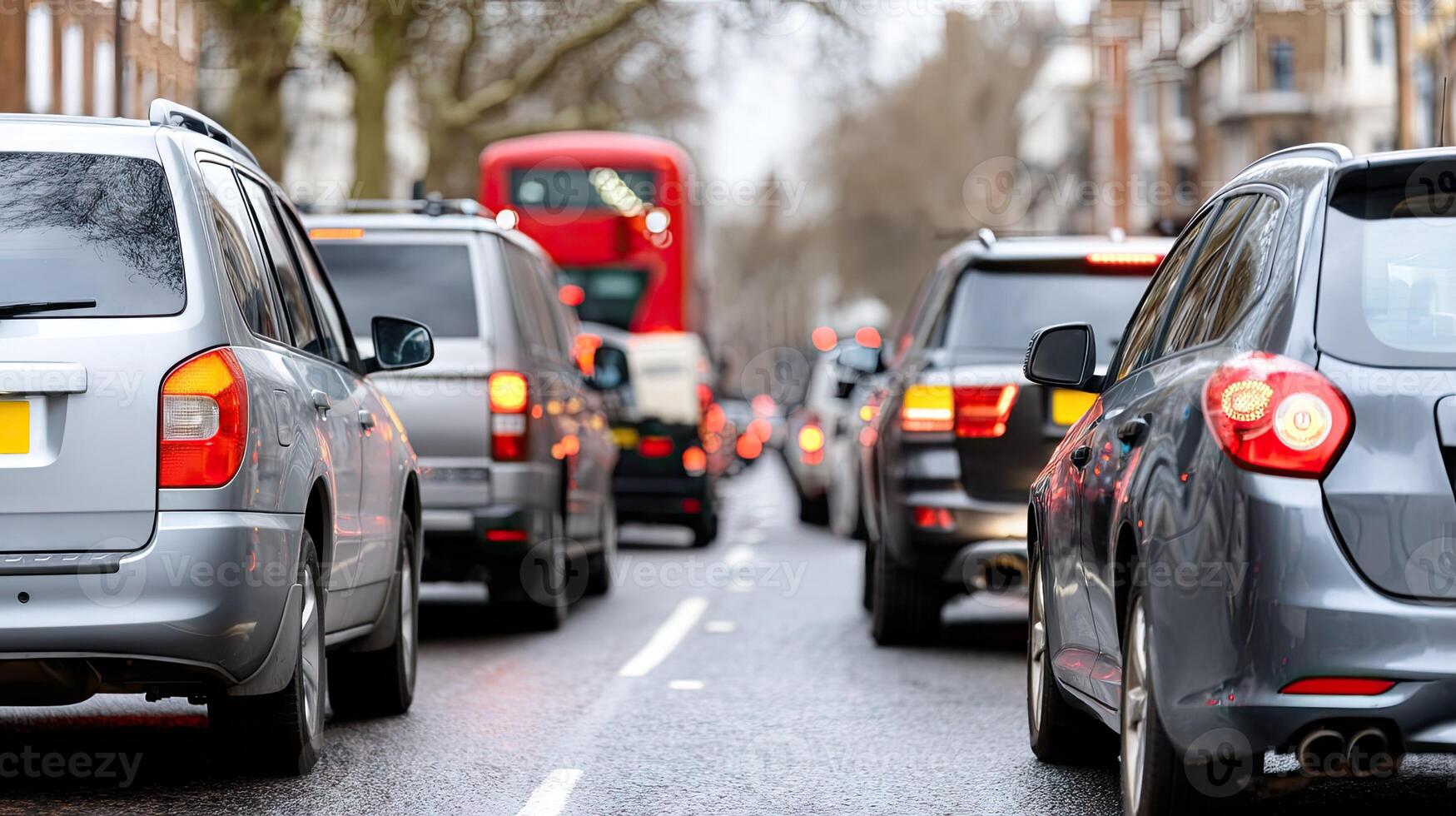 Many cars are driving down the street in traffic photo
