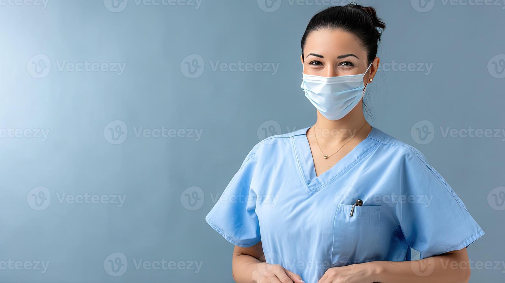 A woman in scrub clothes with a surgical mask photo