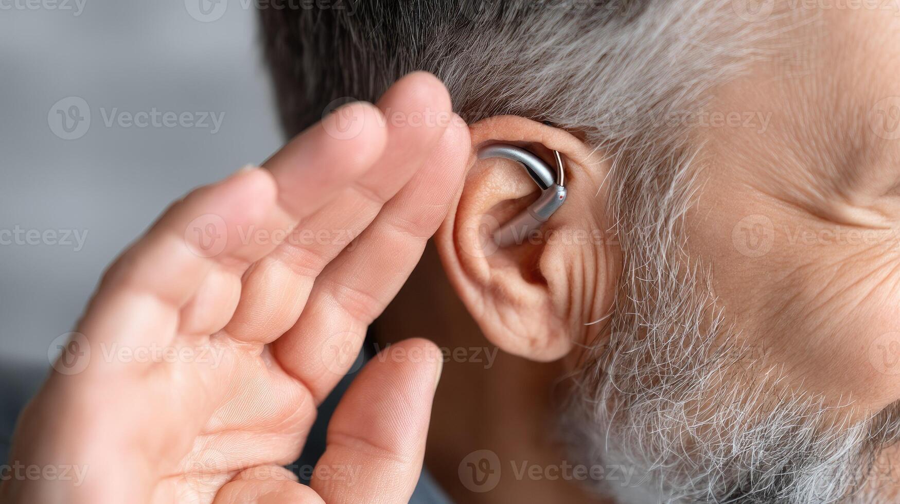 A man with a hearing aid in his ear photo