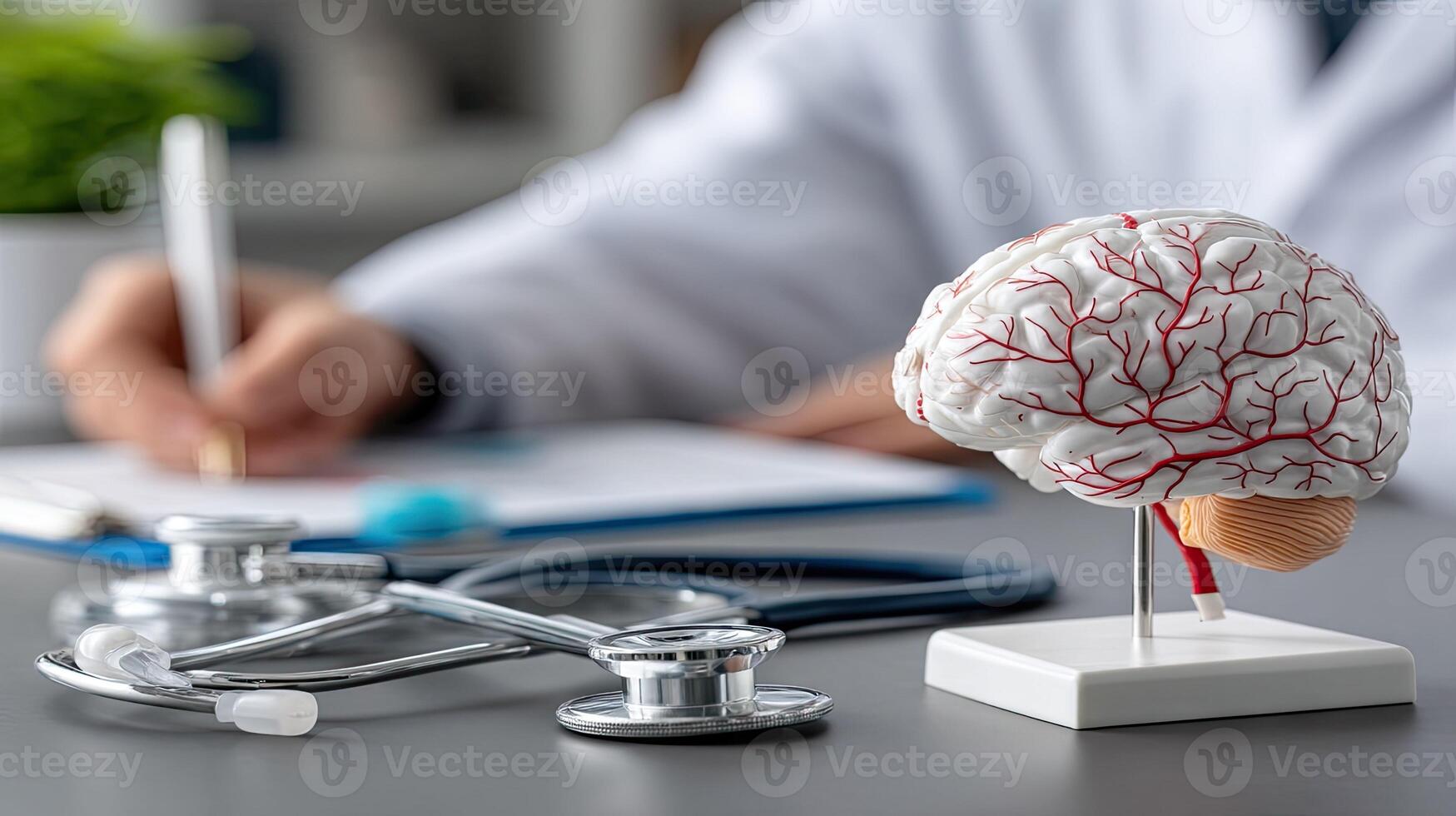A doctor is writing on a piece of paper with a model of a brain photo