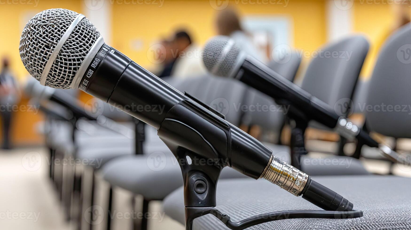 Microphones on a row of chairs in a conference room photo
