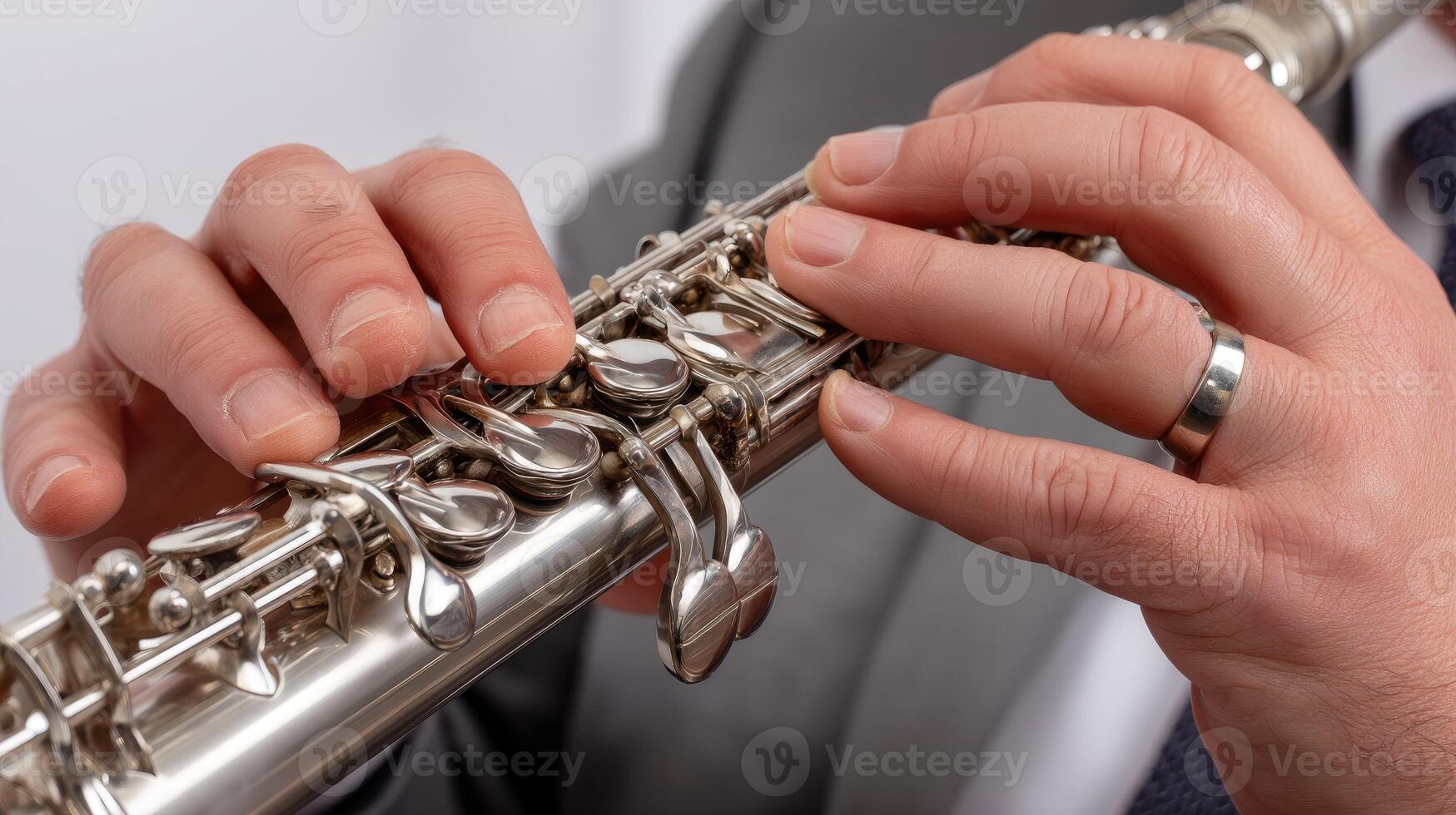 A person in a suit is playing a clarinet photo