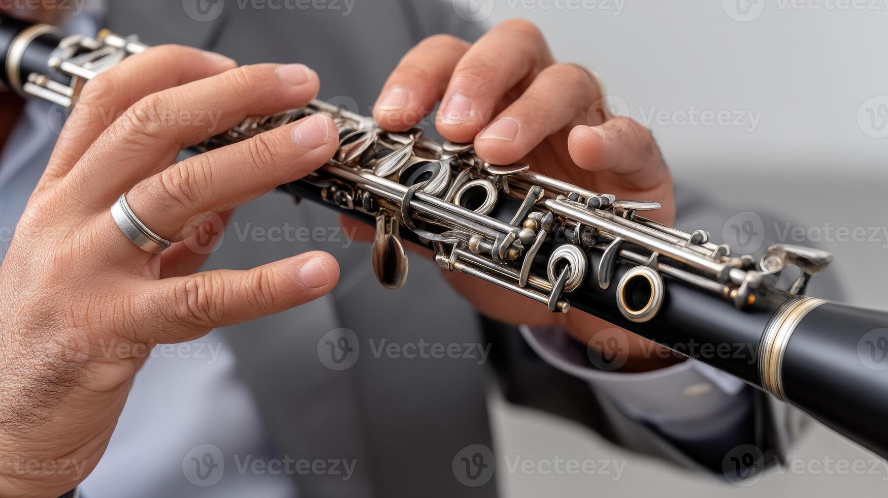 A man in a suit is playing a clarinet photo