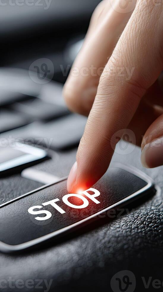 A person pressing a button on a car with the word stop photo