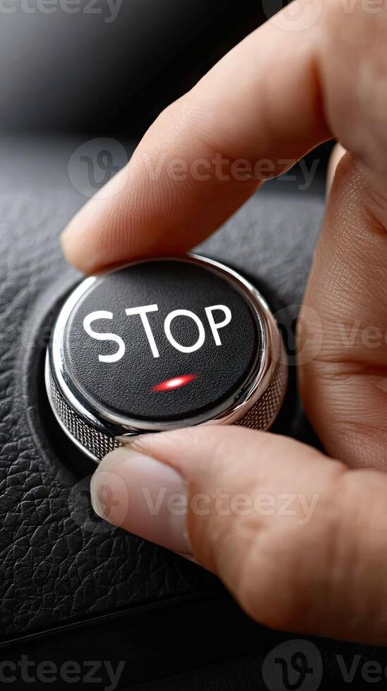 A person is pressing a stop button on a car photo