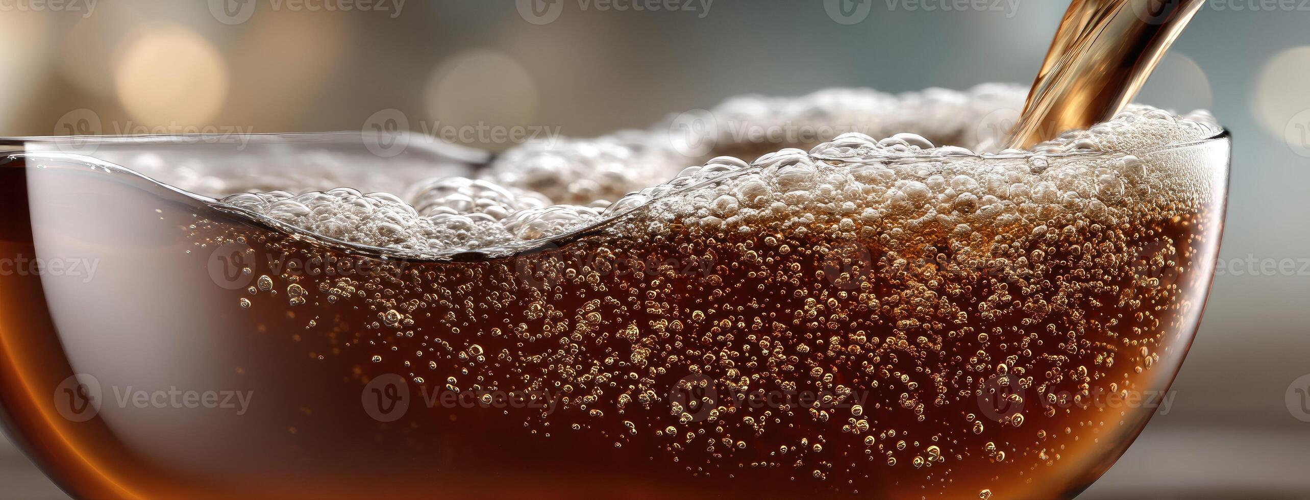 A glass of soda being poured into a glass photo