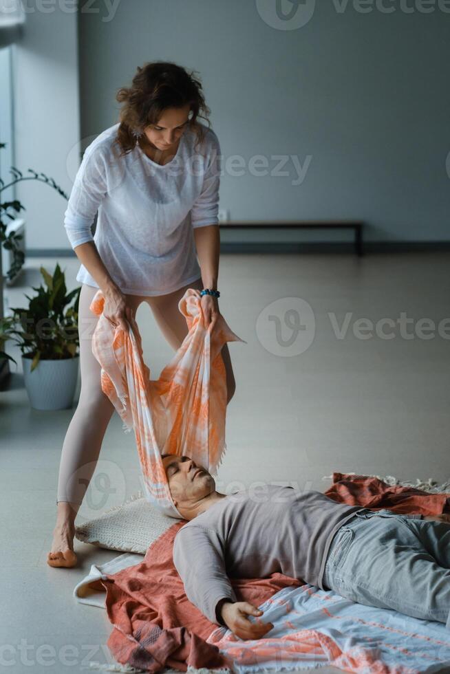 Healing session in a serene studio with a therapist assisting a patient in a laid-back atmosphere on a tranquil morning. photo