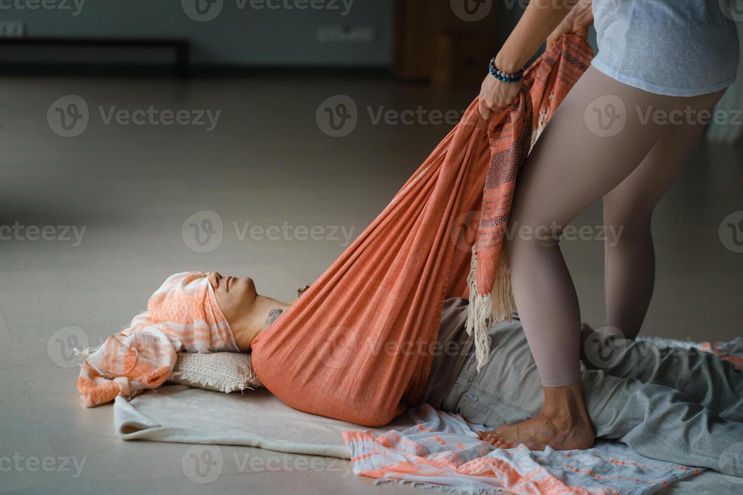 Relaxation and healing during a restorative yoga session with supportive props in a serene indoor environment... photo