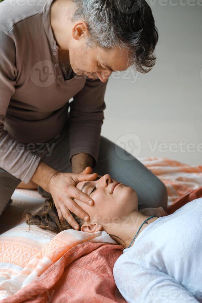 Relaxing massage therapy session focusing on facial techniques in a serene indoor setting during daylight hours. photo
