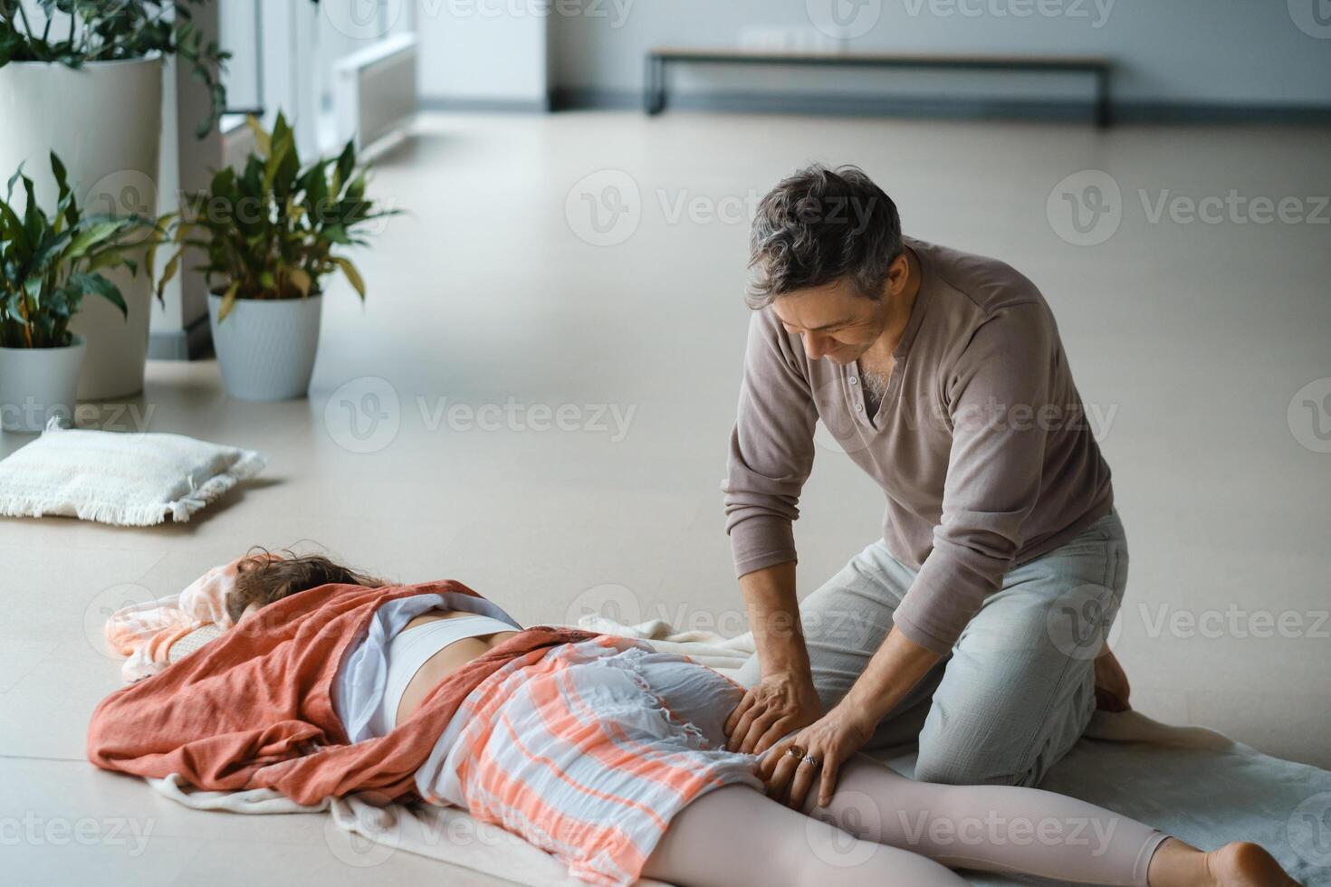 Relaxation therapy session taking place in a serene indoor studio with plants, focusing on wellness and rejuvenation in a tranquil environment. photo