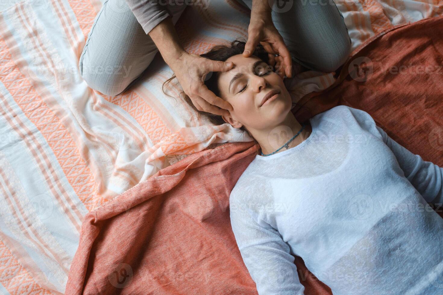 Relaxation and healing through gentle massage in a serene indoor setting during a wellness session photo