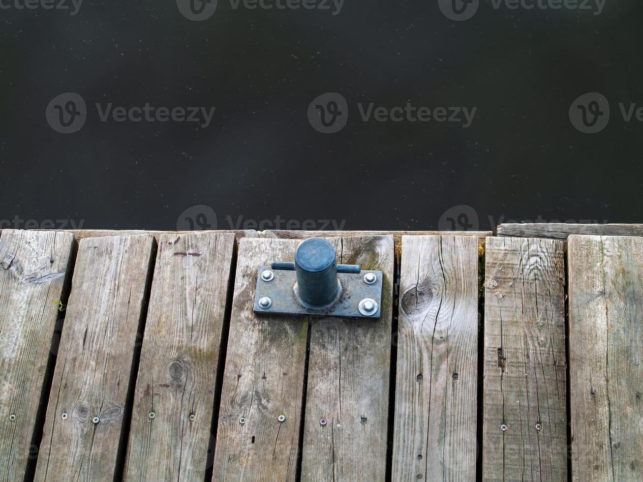 Metal object is sitting on a wooden dock. Zagrze lake, Poland photo