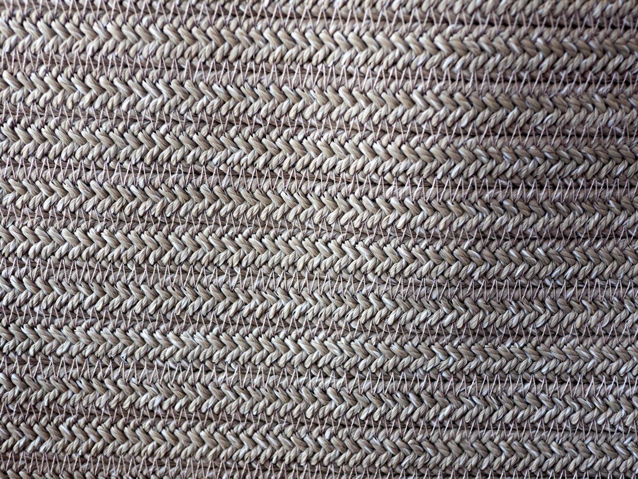 Close up of a woven fabric with a pattern of white and brown photo