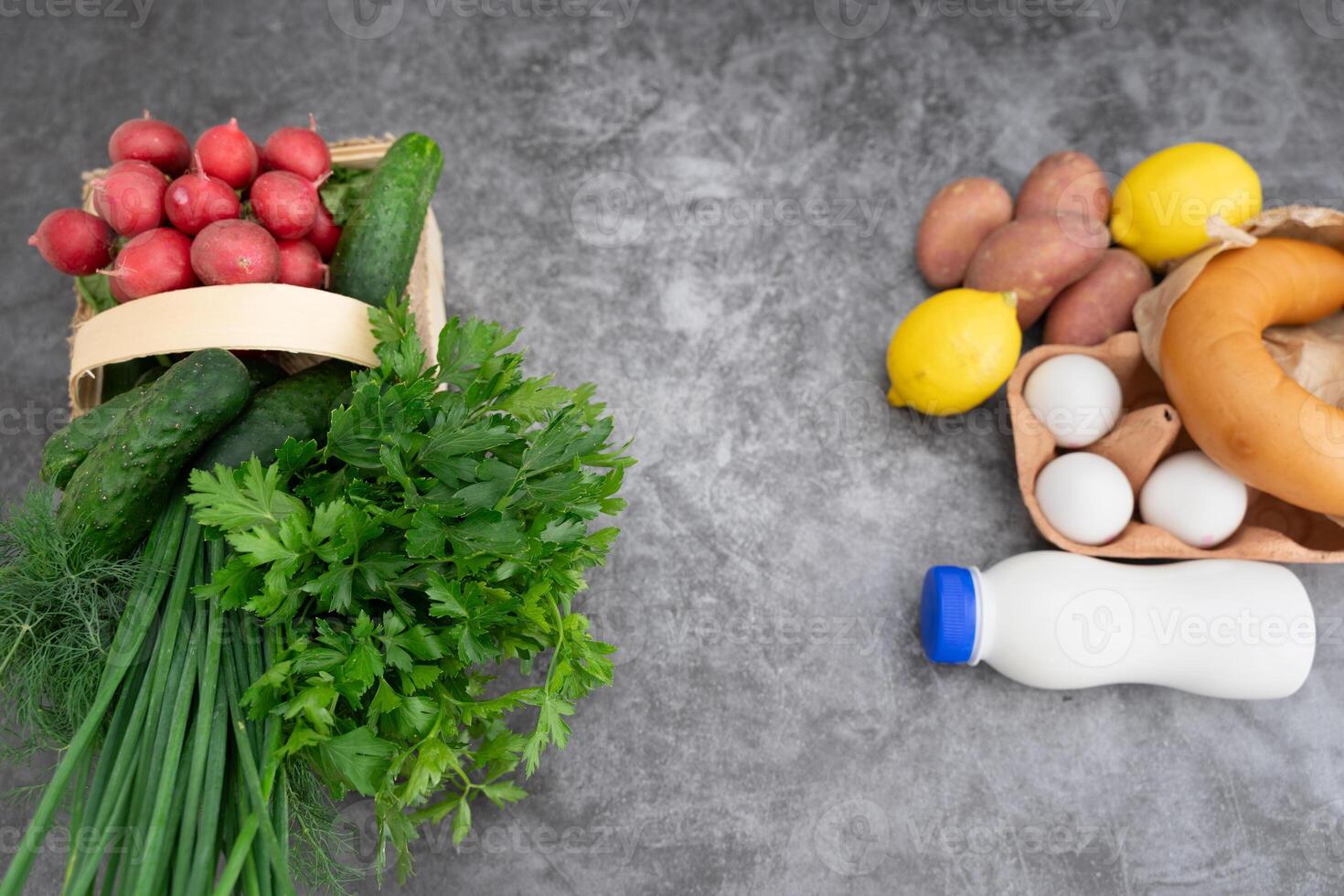 A well-balanced flatlay of okroshka essentials arranged on a neutral gray background. photo