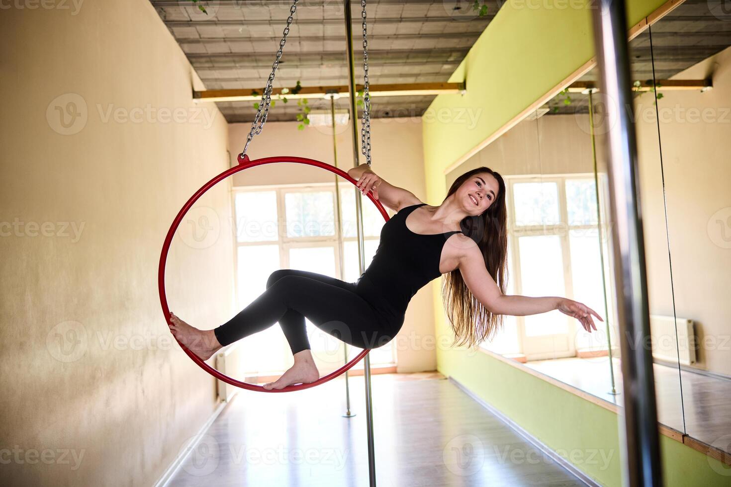 Graceful Woman Doing Acrobatics On Aerial Hoop photo