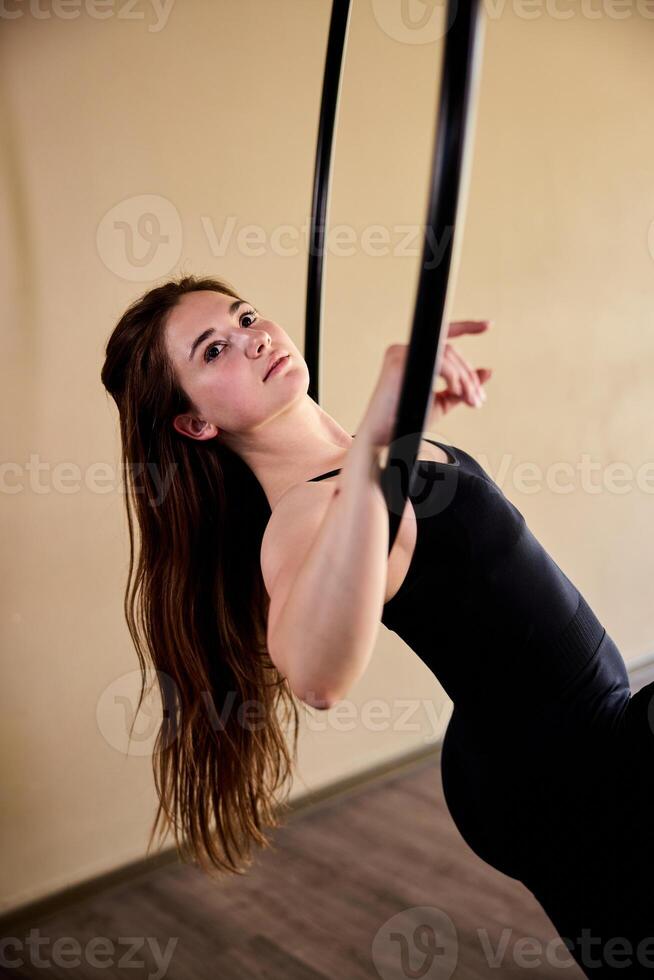 Woman in black Doing Acrobatics On Aerial Hoop photo