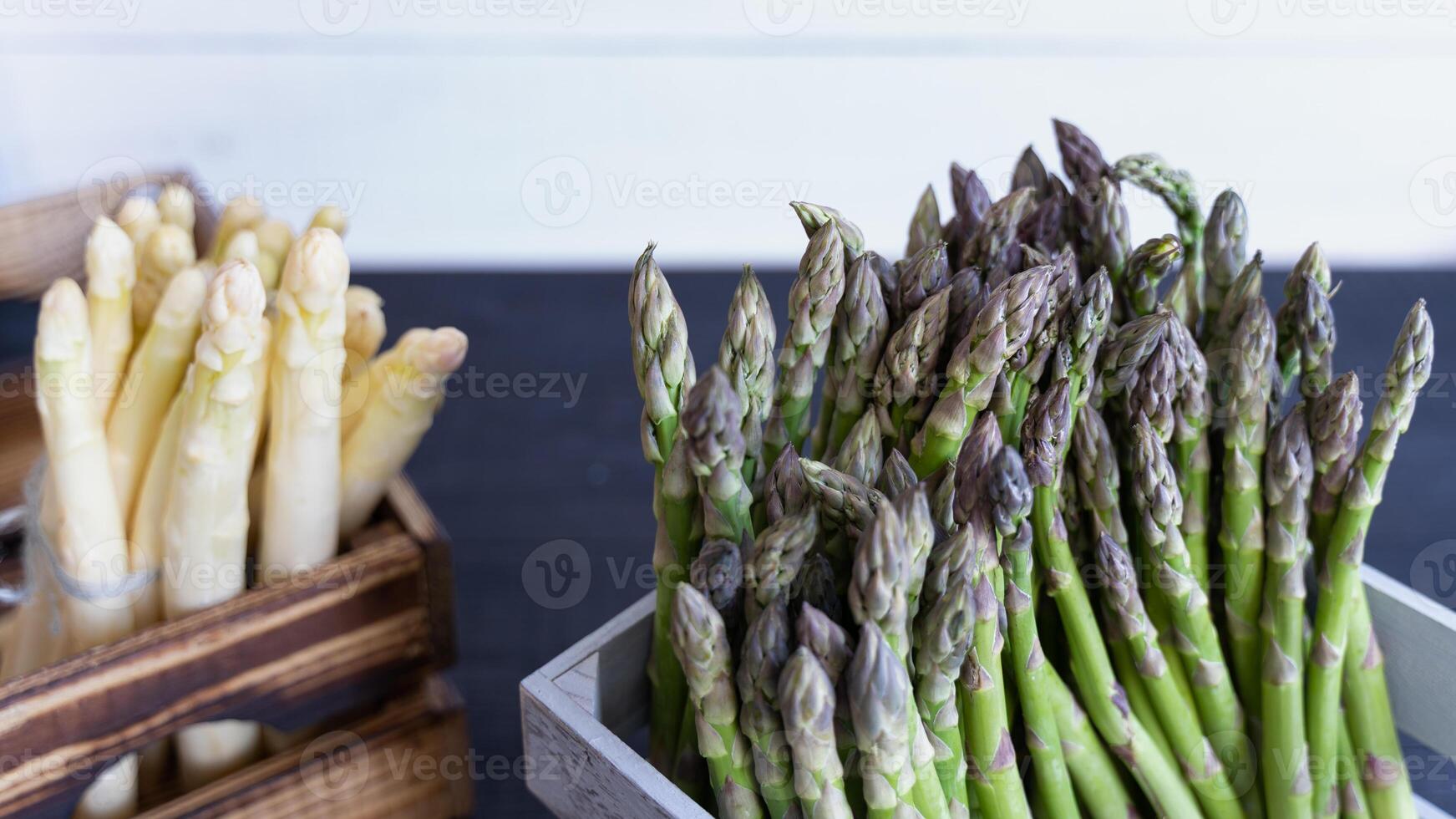A visual contrast of green and white asparagus in rustic crates, ideal for spring harvest themes. photo