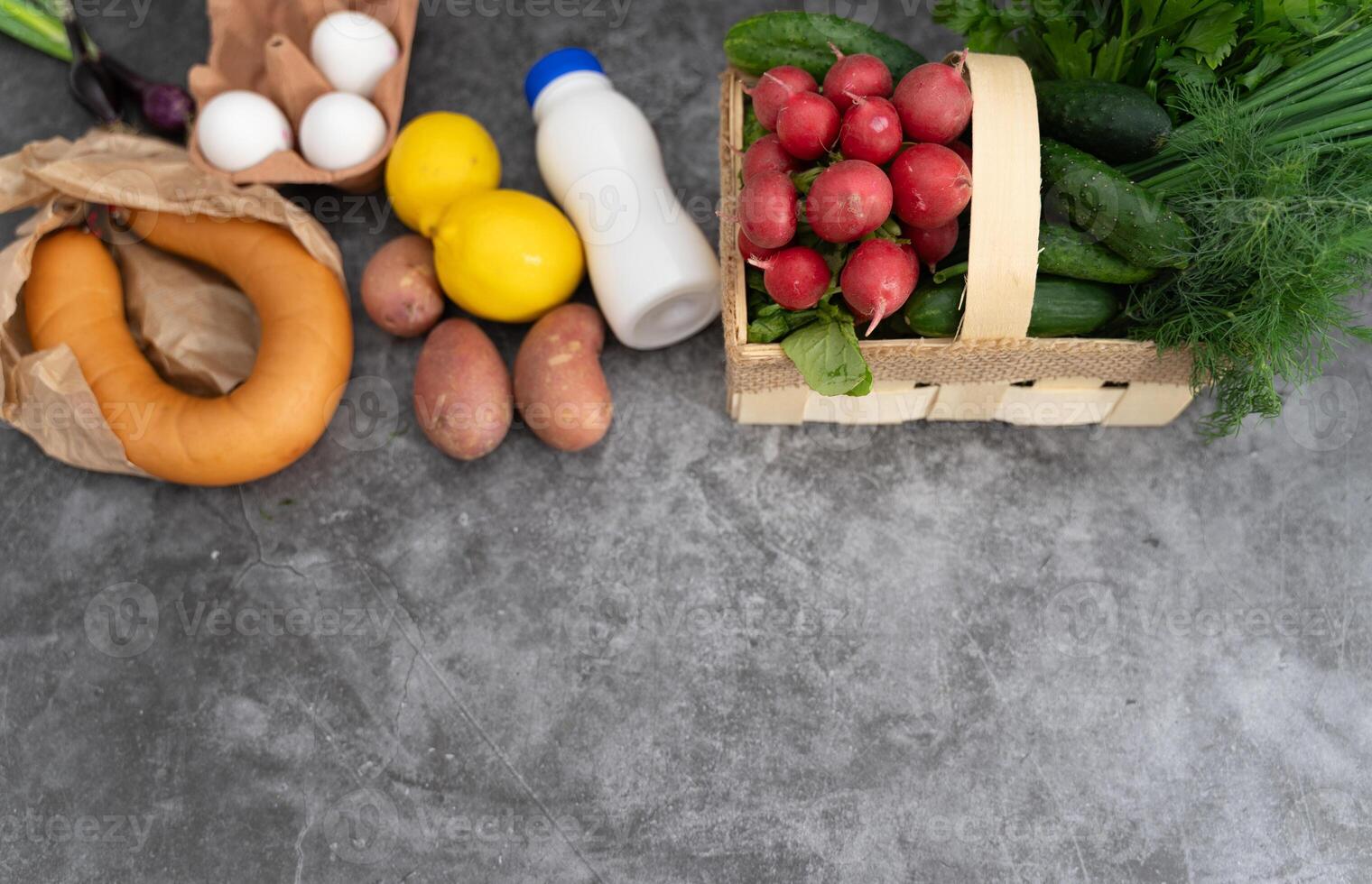 A top-down view of raw okroshka ingredients showcasing texture and color on a gray surface photo