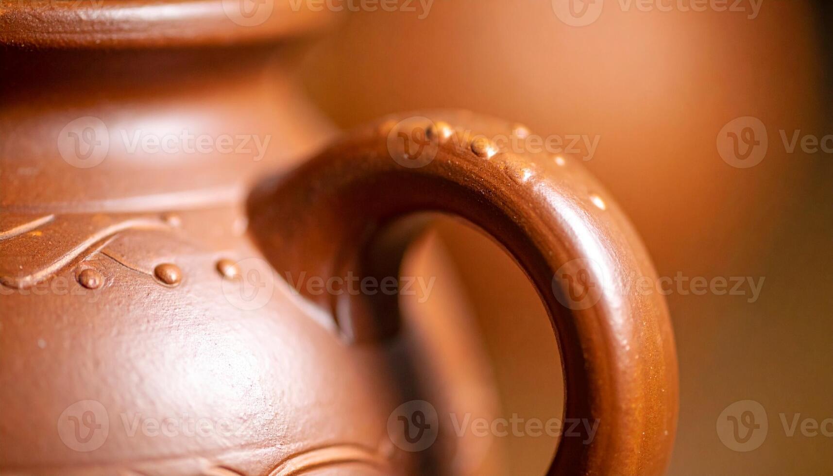 Handcrafted Clay Pot Showcasing Intricate Design and Smooth Handle in a Rustic Workshop Setting, Emphasizing Traditional Pottery Techniques photo
