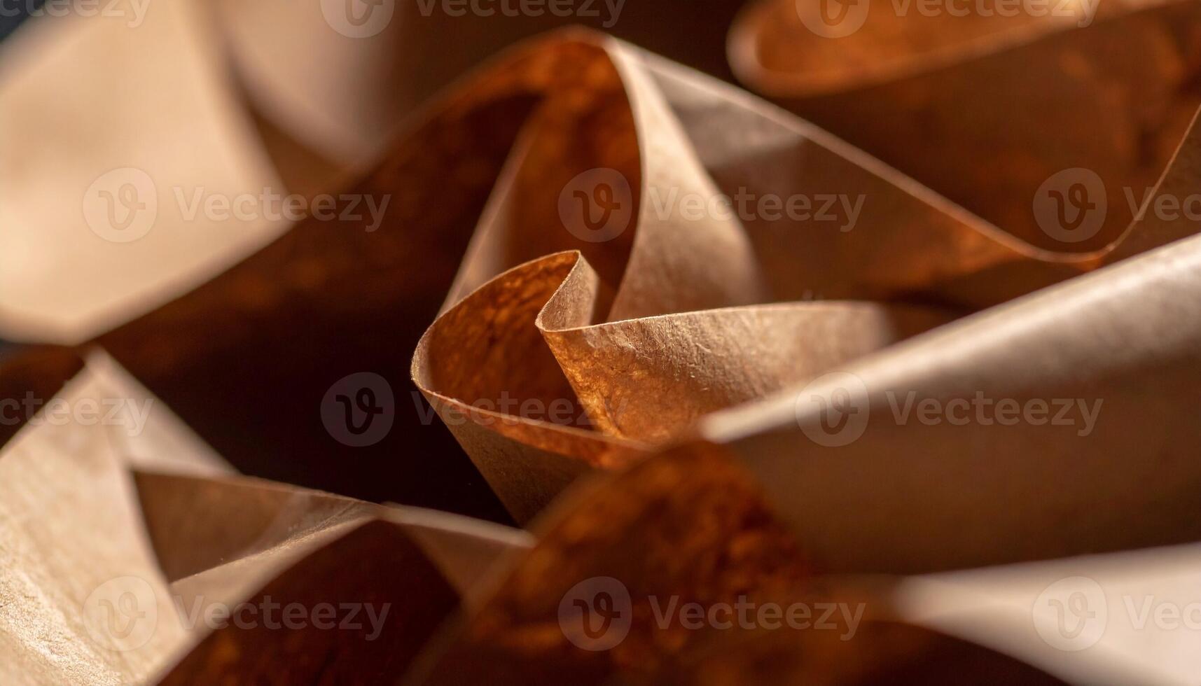 Detailed View of Crumpled Brown Paper Forming Artistic Shapes and Patterns in a Creative Workspace photo