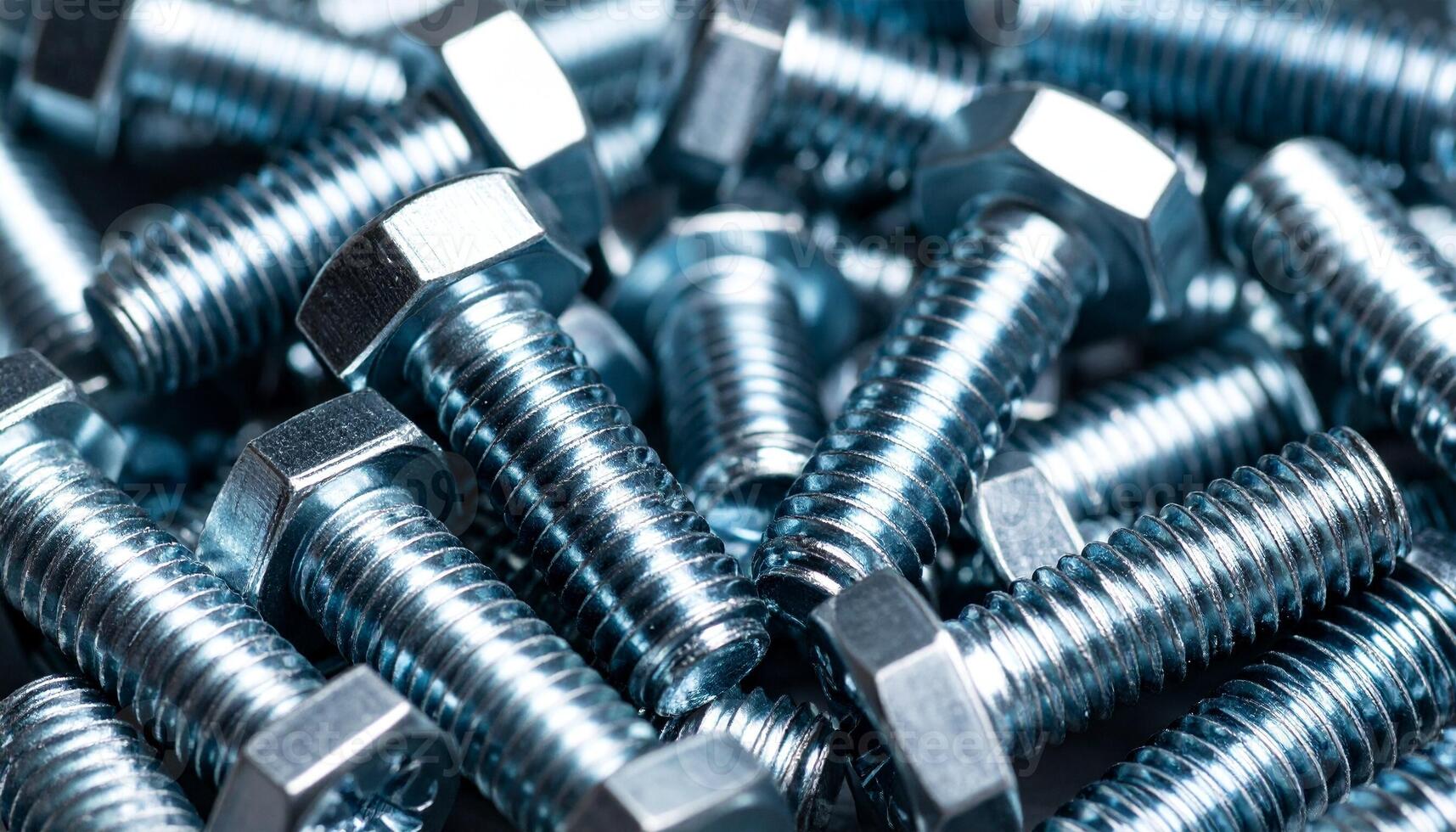 Metallic Bolts Arranged Densely With a Shiny Finish, Showcasing Intricate Threading and Design Characteristics photo