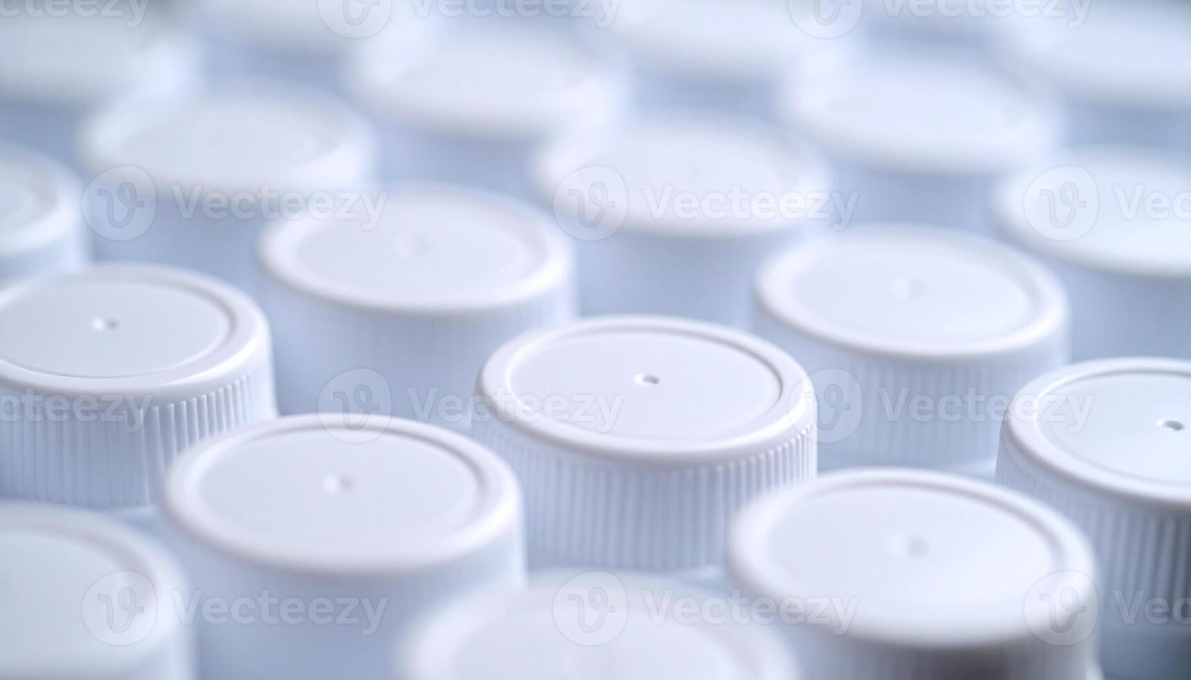 Bottles Lined With White Caps Arranged Neatly in a Factory Setting During the Daytime photo