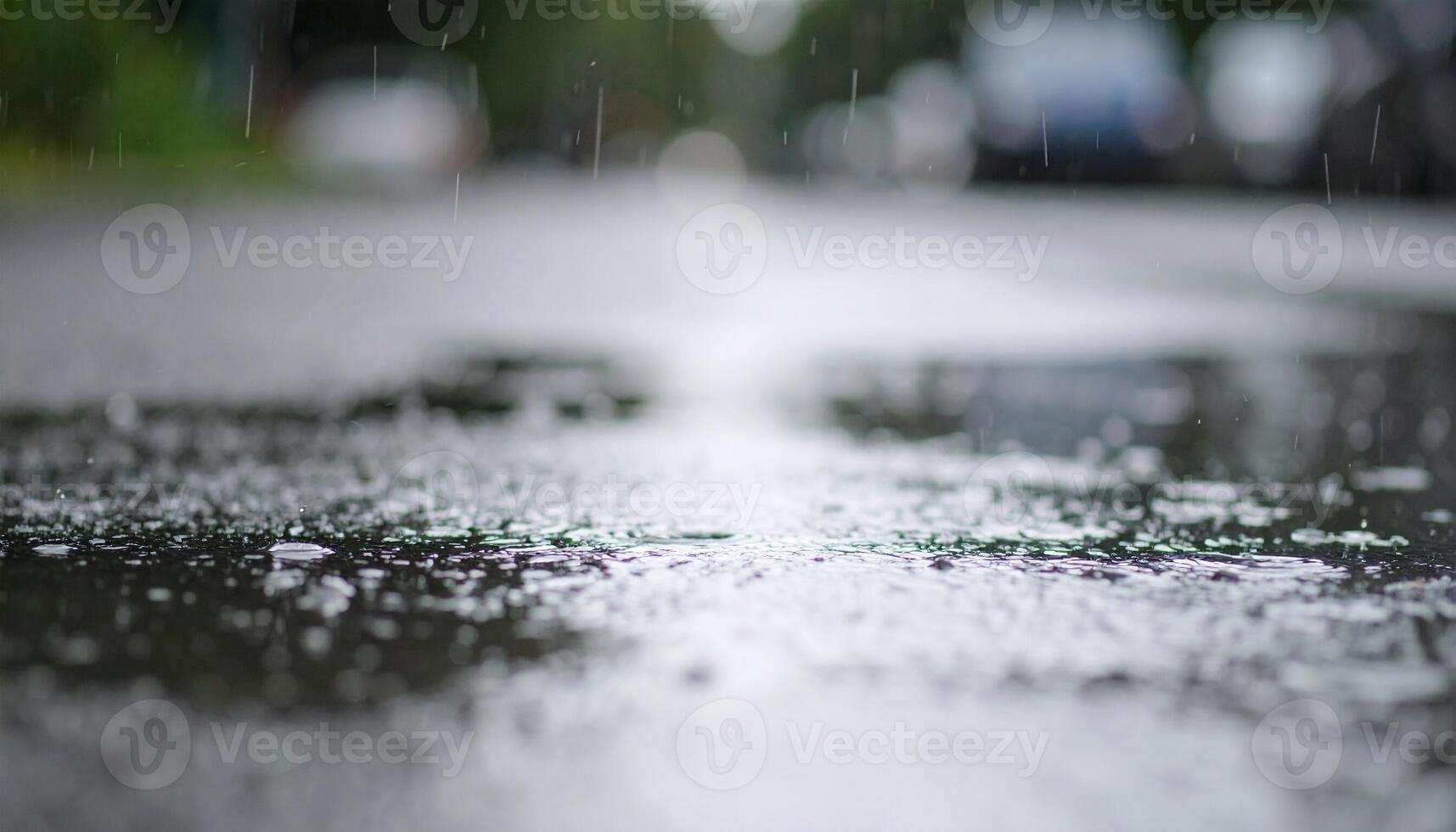 Rain Falling on a Wet Street With Reflections in the Water During a Cloudy Day photo