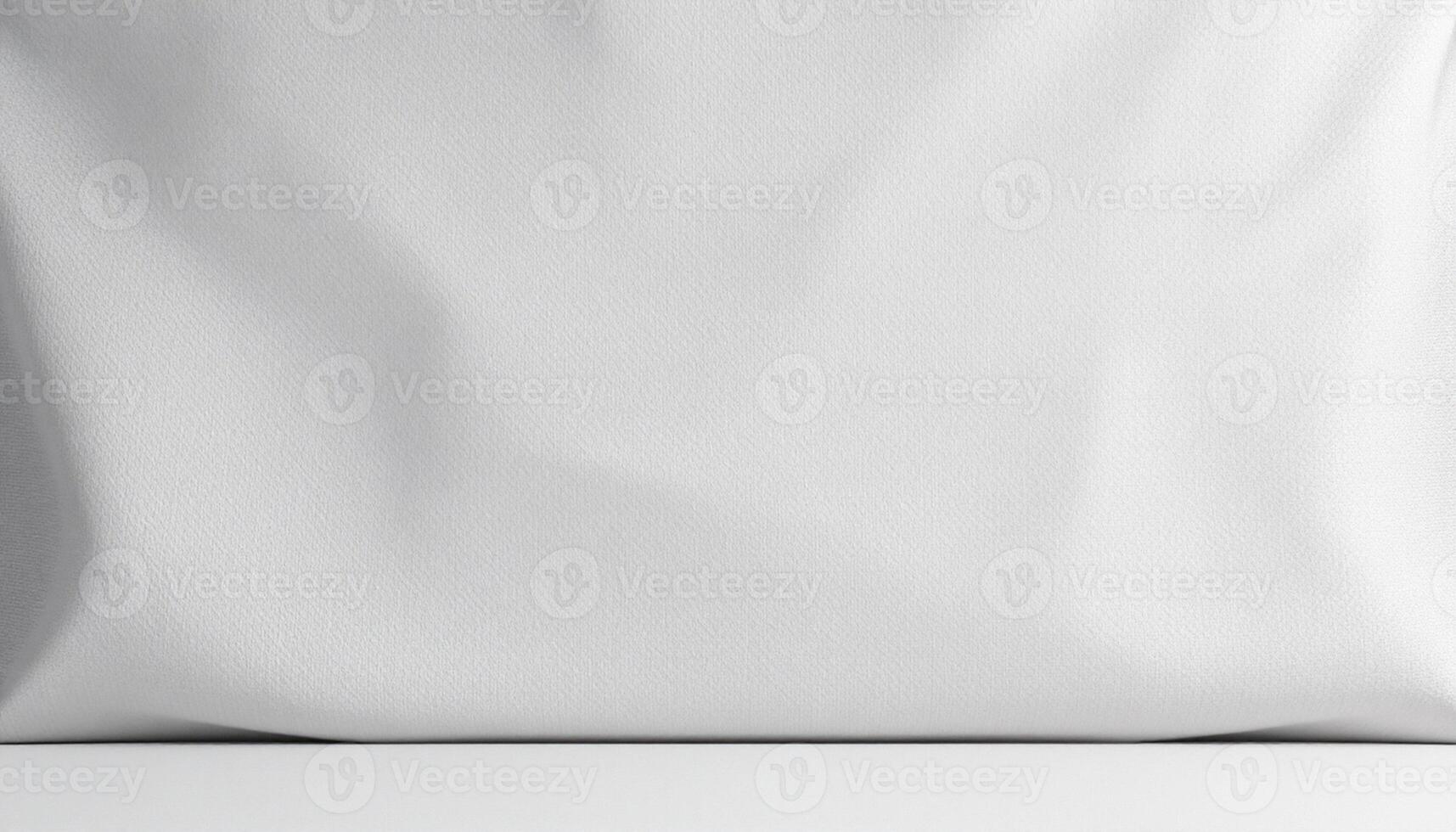 A white pillow with a white cover on a white surface photo
