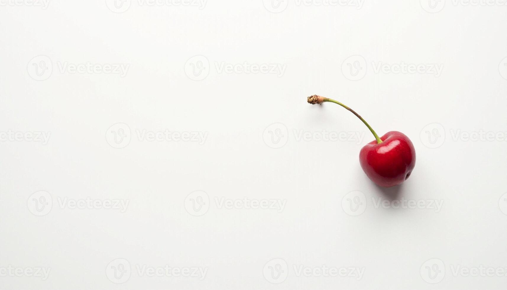 Cherry leaning slightly on neutral light background. photo