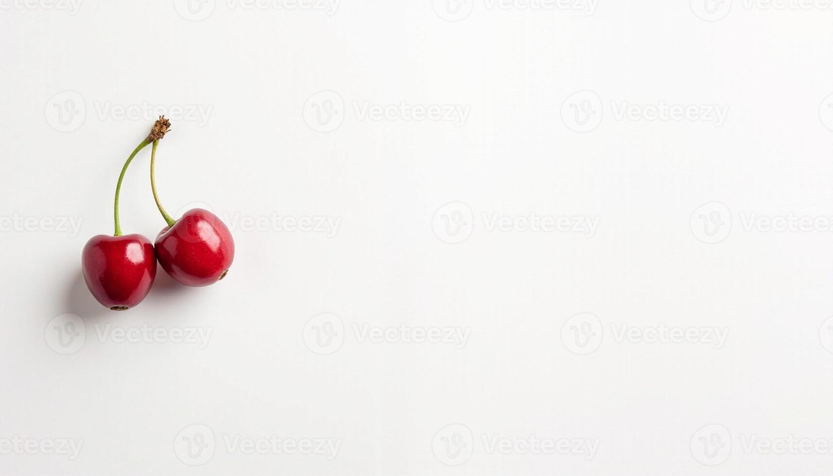 Two red cherries angled together on light clean surface. photo