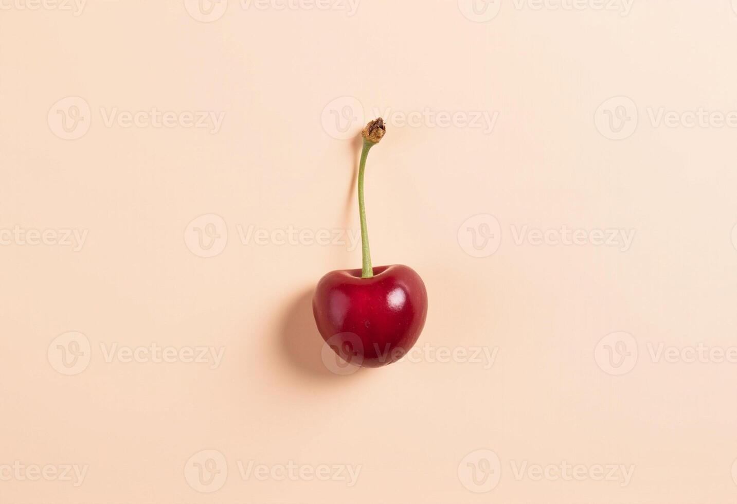 Minimal cherry isolated on pale pink backdrop with soft shadow. photo