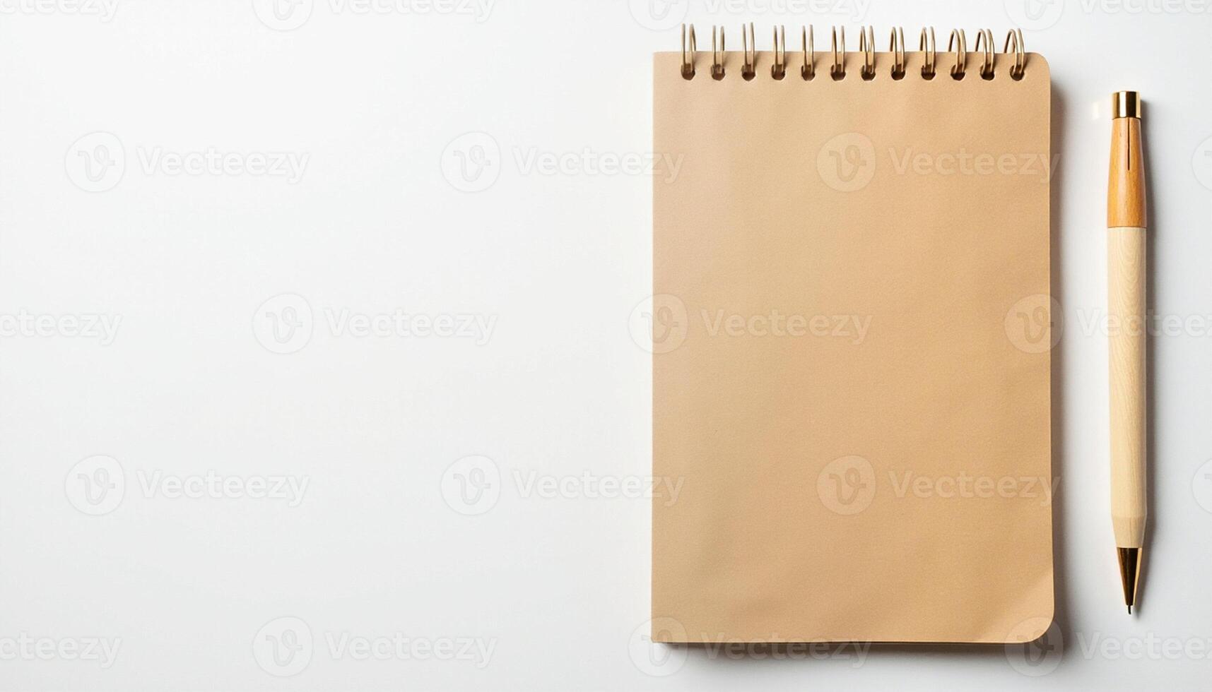 Top view of kraft spiral notebook and pen on clean white background. photo