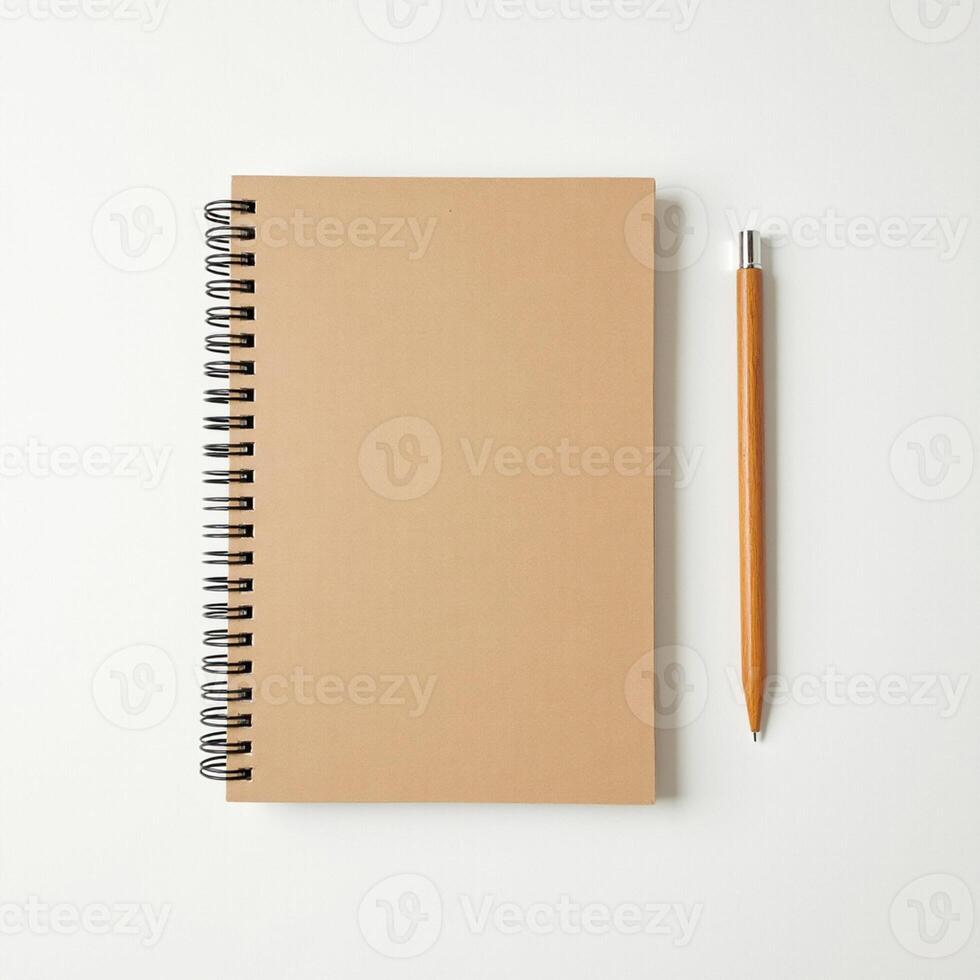 Minimalist flat lay of spiral notebook with pencil on clean white desk. photo