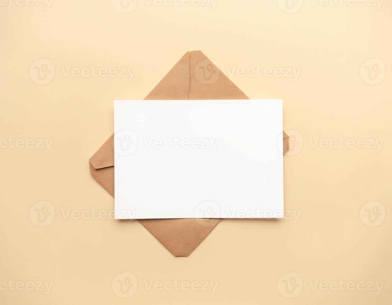 Blank white envelope with brown envelope on beige background photo