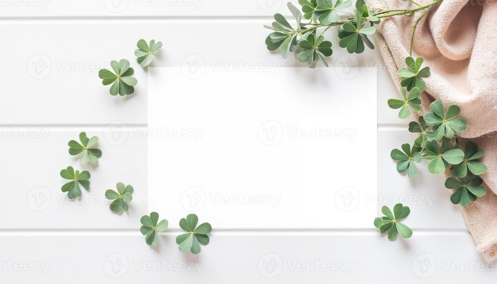 Blank paper with shamrock leaves on white background photo