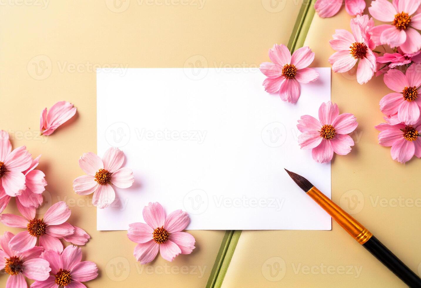 Blank paper with pink flowers and a pen on a yellow background photo