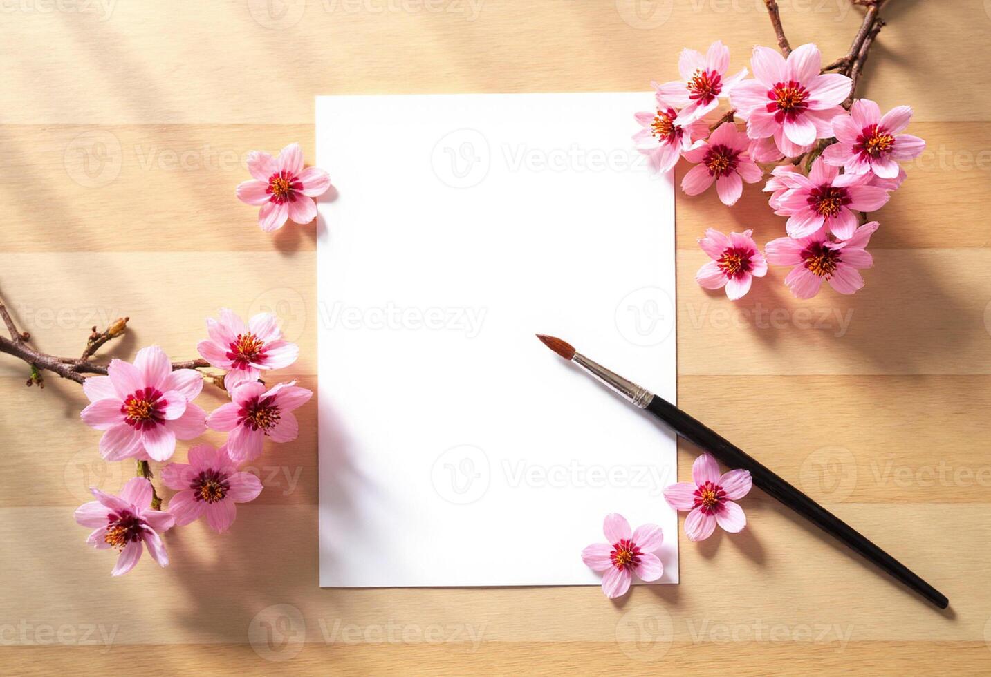 Blank paper with cherry blossom on wooden table with brush and copy space for text photo