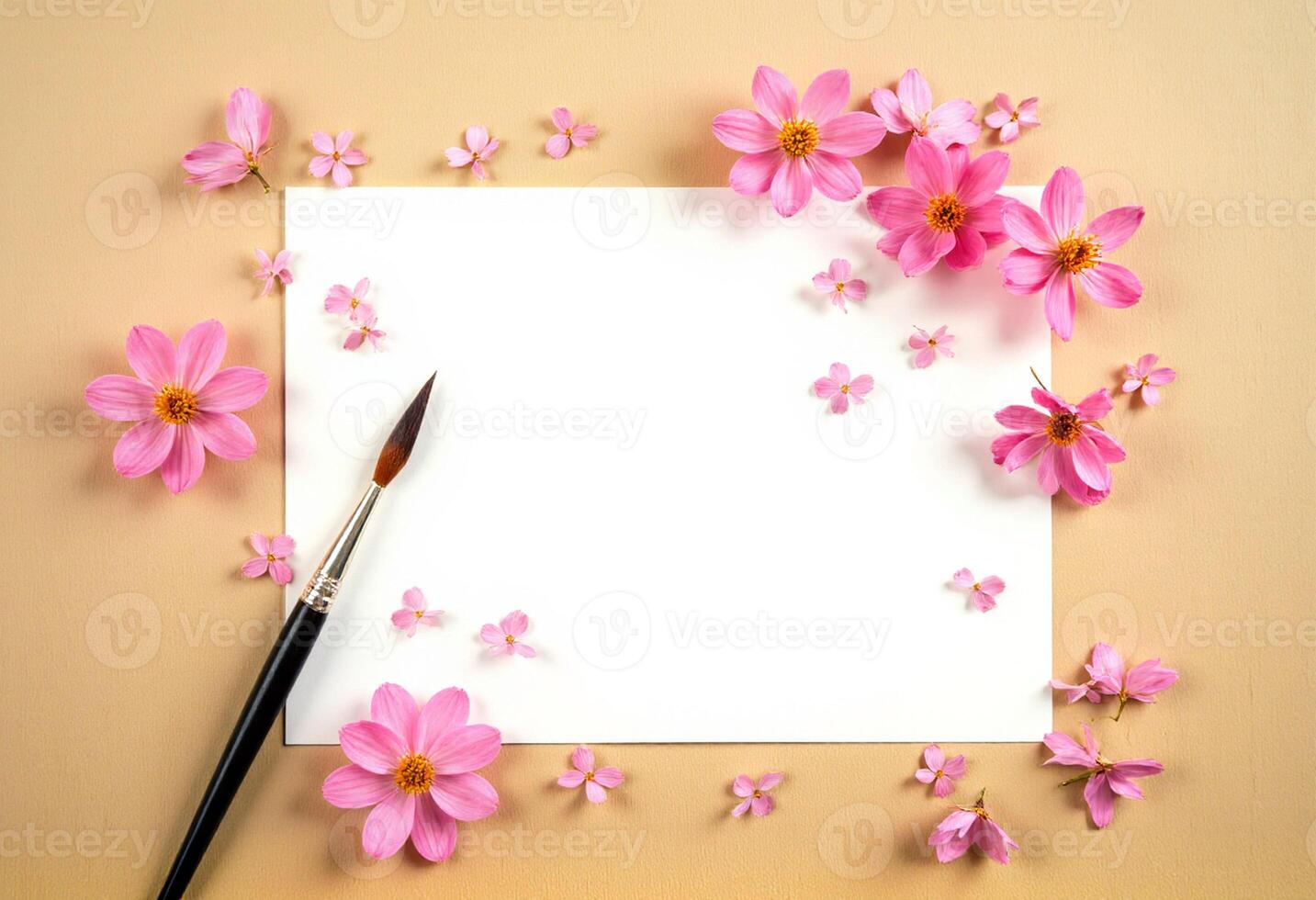 Pink flowers and a blank paper on a beige background photo