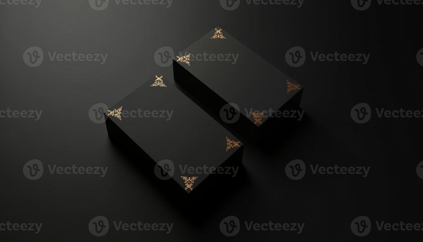 Two black boxes with gold designs on them photo
