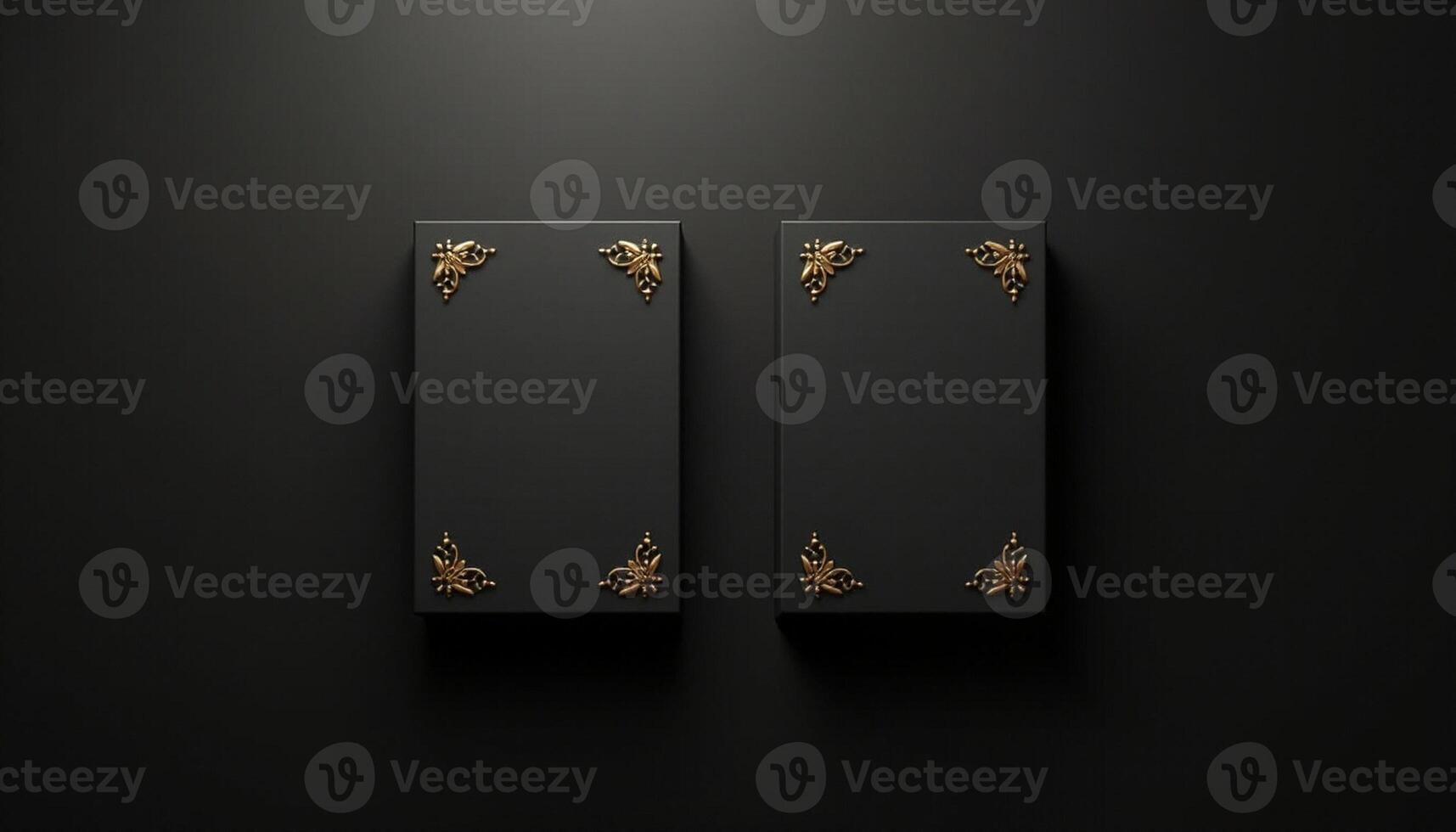 Two black boxes with gold decorations on a black background photo