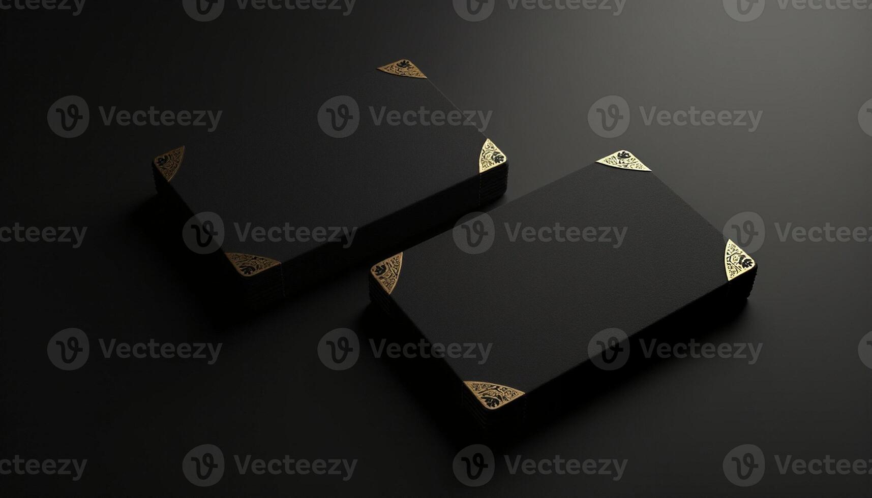 Two black boxes with gold accents on a black surface photo